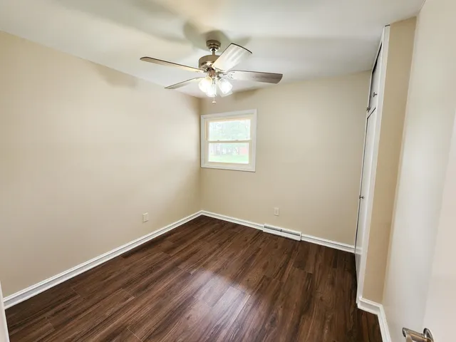 a view of an empty room and wooden floor