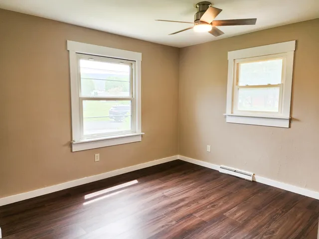 a view of a wooden deck and a yard with green space