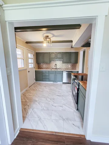 an empty room with wooden floor and window