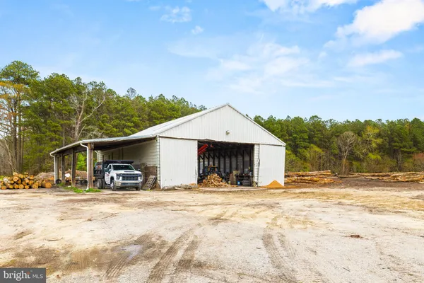 a view of a house with snow on the road