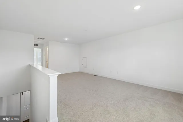 an empty room with a empty space and windows