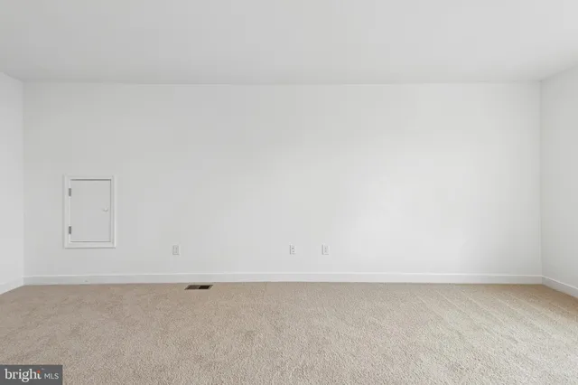 a view of a white house with a big yard and large trees