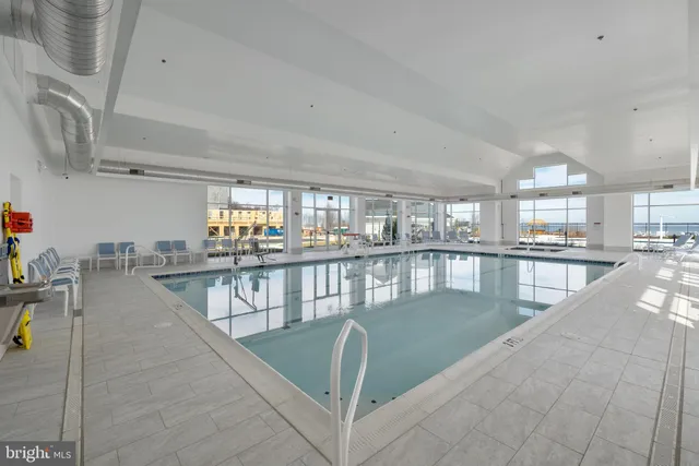 a view of a swimming pool with lawn chairs