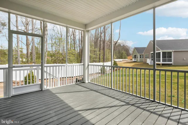 a view of a balcony with floor to ceiling windows with wooden floor