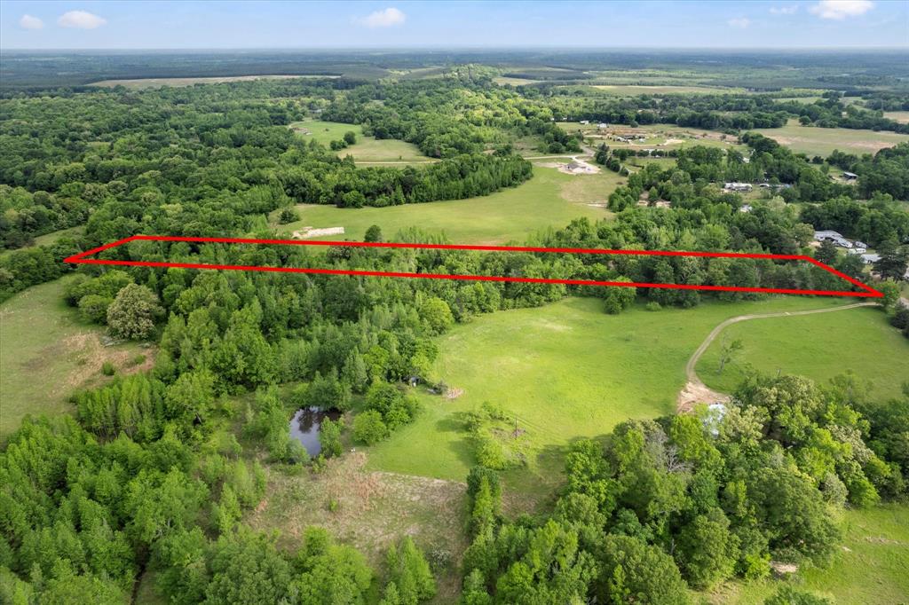 2152 Rd Mount Mount Pleasant, TX 75455 - Photo 3 of 7 Aerial view featuring a wooded view