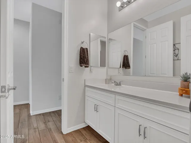 a bathroom with a double vanity sink and mirror