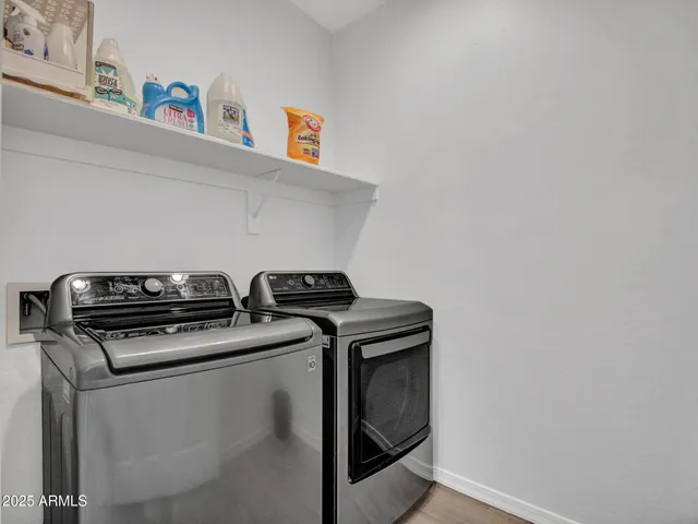 a bedroom with a large bed and a potted plant