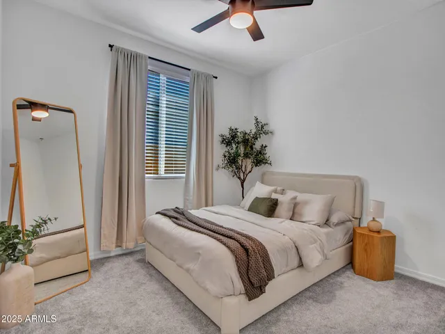 a bedroom with a bed and a potted plant