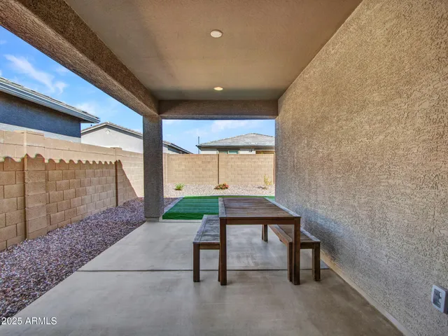 a view of a patio with a table and chairs