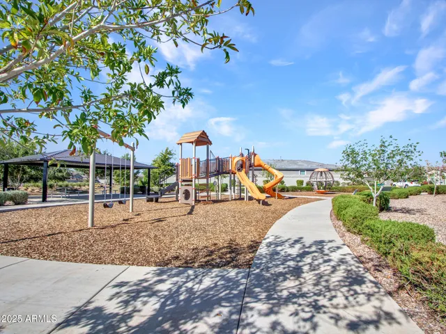 a room with painting on the wall and a potted plant