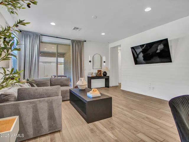 a living room with furniture and a wooden floor