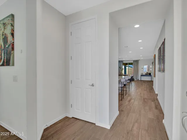 view of a hallway with wooden floor windows and livingroom