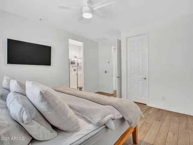 a bedroom with a bed and a flat screen tv