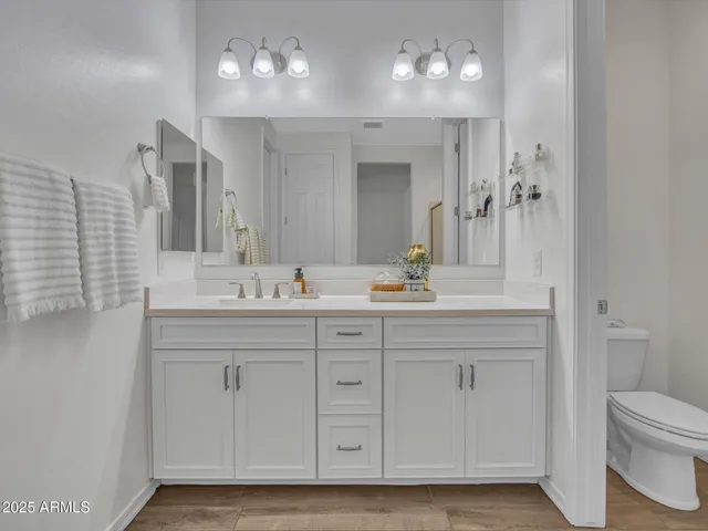 a bathroom with a sink vanity and a mirror