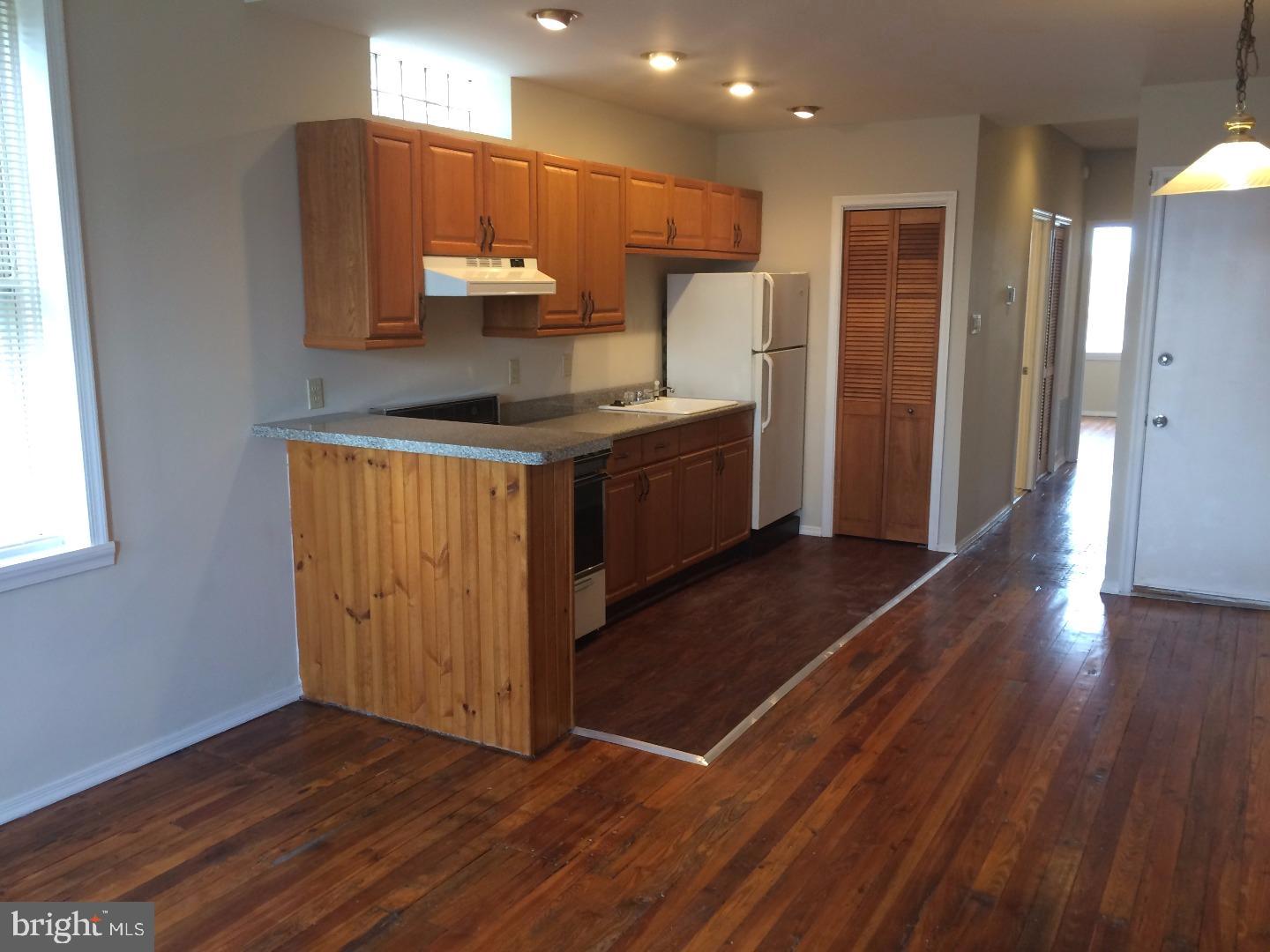 2025 South 3rd Street, Unit 3 Philadelphia, PA 19148 - Photo 3 of 7 a kitchen with stainless steel appliances granite countertop a refrigerator a sink and a stove