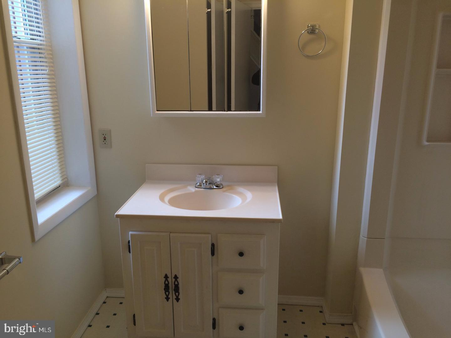 2025 South 3rd Street, Unit 3 Philadelphia, PA 19148 - Photo 7 of 7 a bathroom with a sink and a mirror