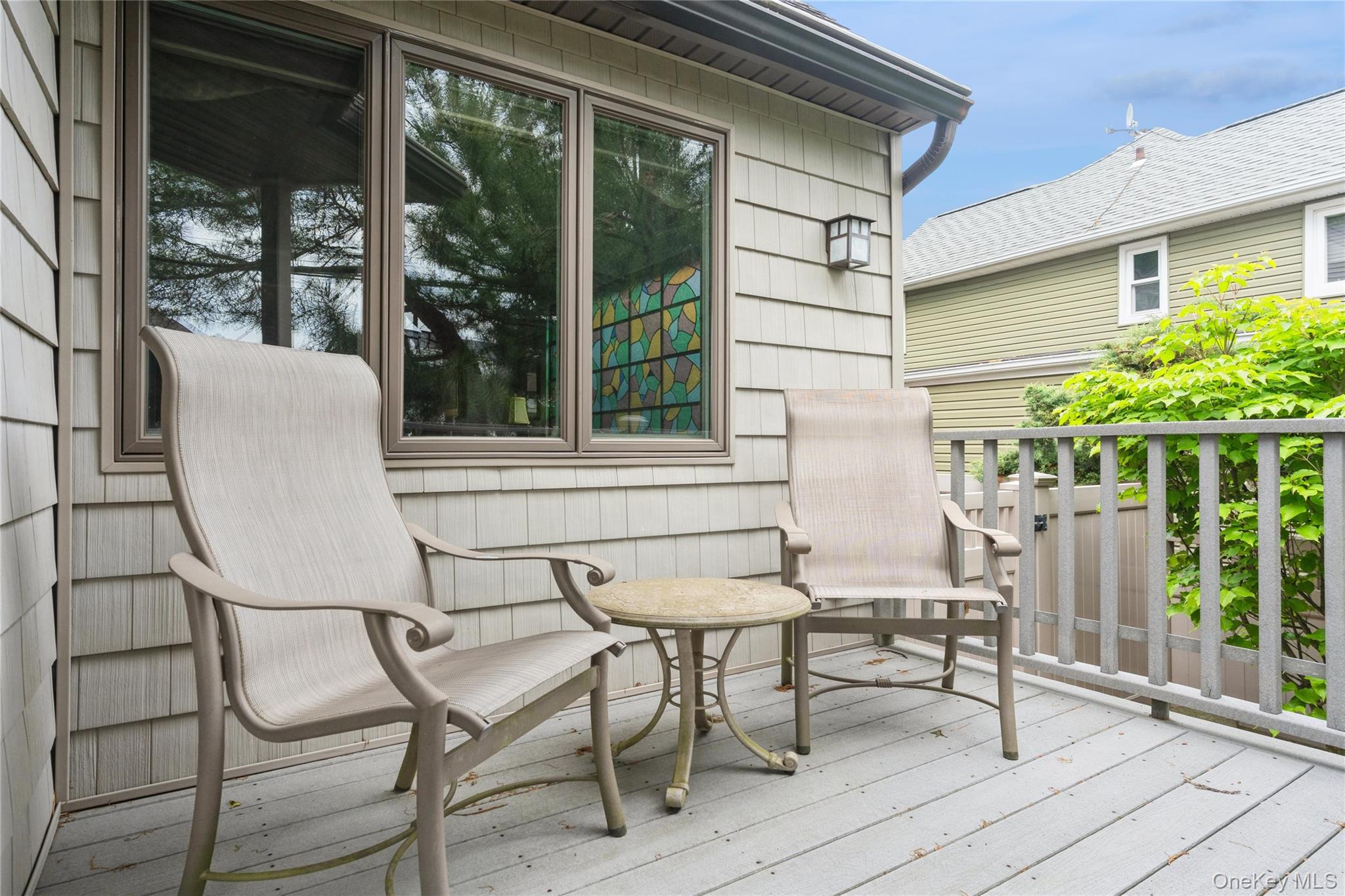 2772 Riverside Avenue Merrick, NY 11566 - Photo 27 of 45 a view of chair and table in the balcony