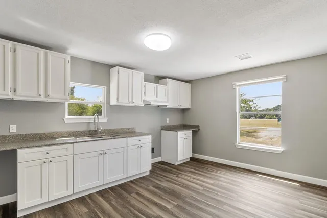 a kitchen with a sink cabinets and window