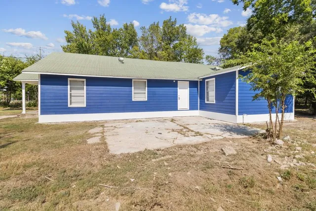 a house that has a tree in front of it