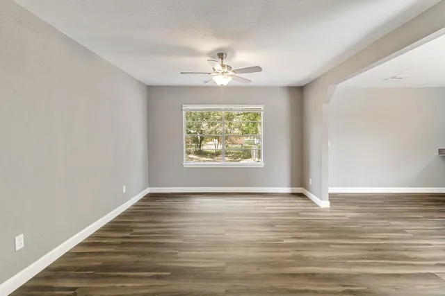 wooden floor in an empty room with a window