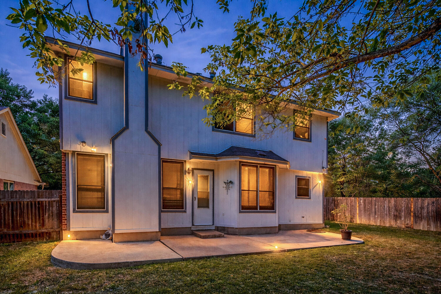 9301 Tea Rose Trail Austin, TX 78748 - Photo 34 of 36 Back of property at dusk with a fenced backyard and a patio area