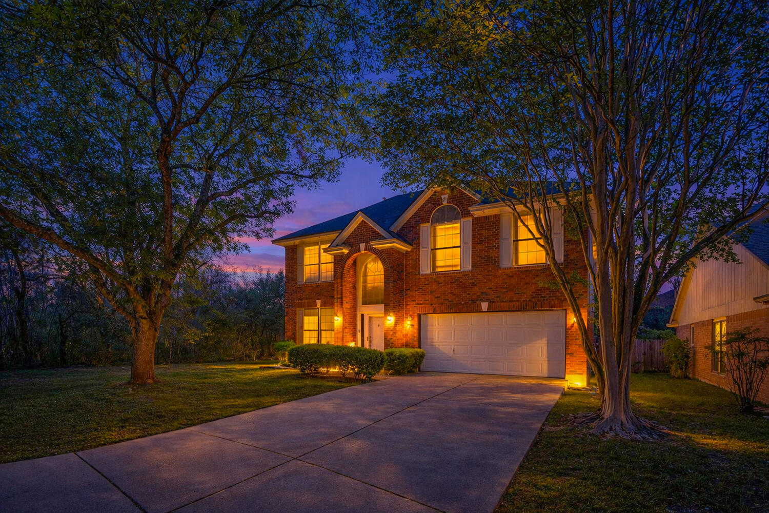 9301 Tea Rose Trail Austin, TX 78748 - Photo 4 of 36 Traditional home with concrete driveway, brick siding, an attached garage, and a lawn
