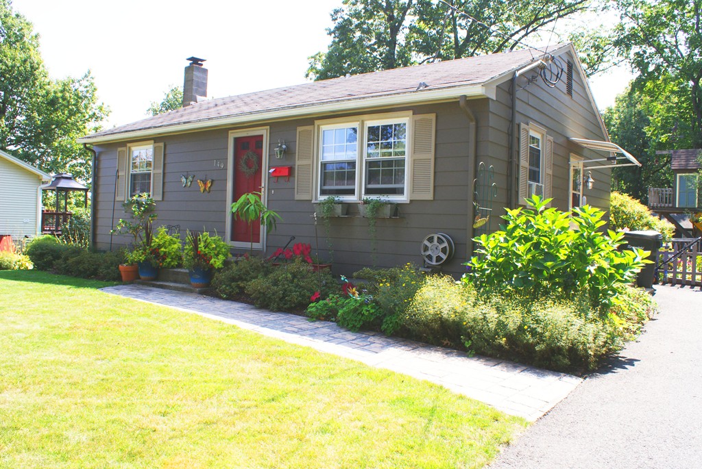 149 Endecott Street Springfield, MA 01118 - Photo 1 of 23 a front view of a house with garden