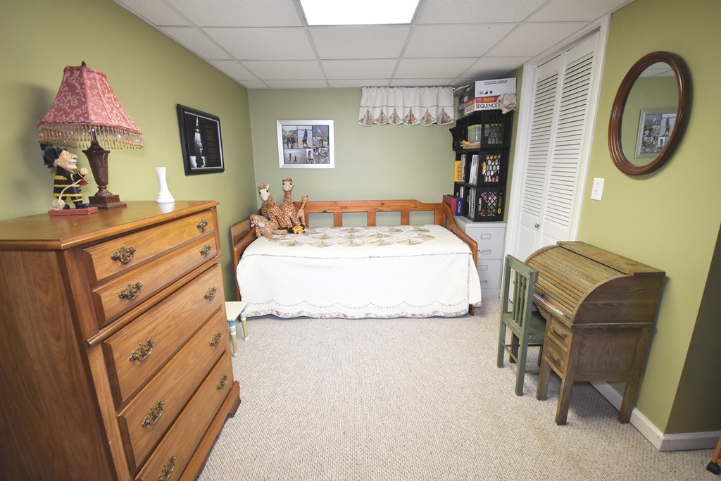 149 Endecott Street Springfield, MA 01118 - Photo 12 of 23 a spacious bedroom with a bed and a chandelier