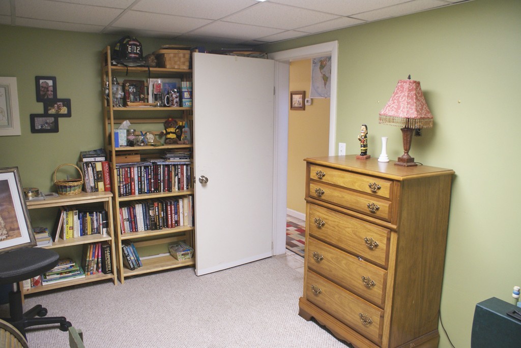 149 Endecott Street Springfield, MA 01118 - Photo 13 of 23 a room with furniture and a book shelf