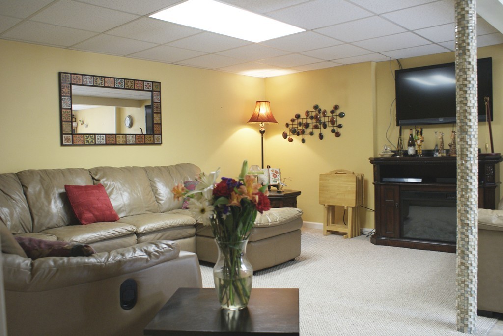 149 Endecott Street Springfield, MA 01118 - Photo 14 of 23 a living room with furniture and a flat screen tv