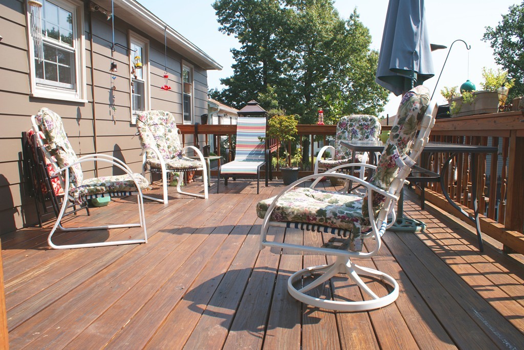149 Endecott Street Springfield, MA 01118 - Photo 21 of 23 a view of a patio with table and chairs potted plants with wooden floor and fence