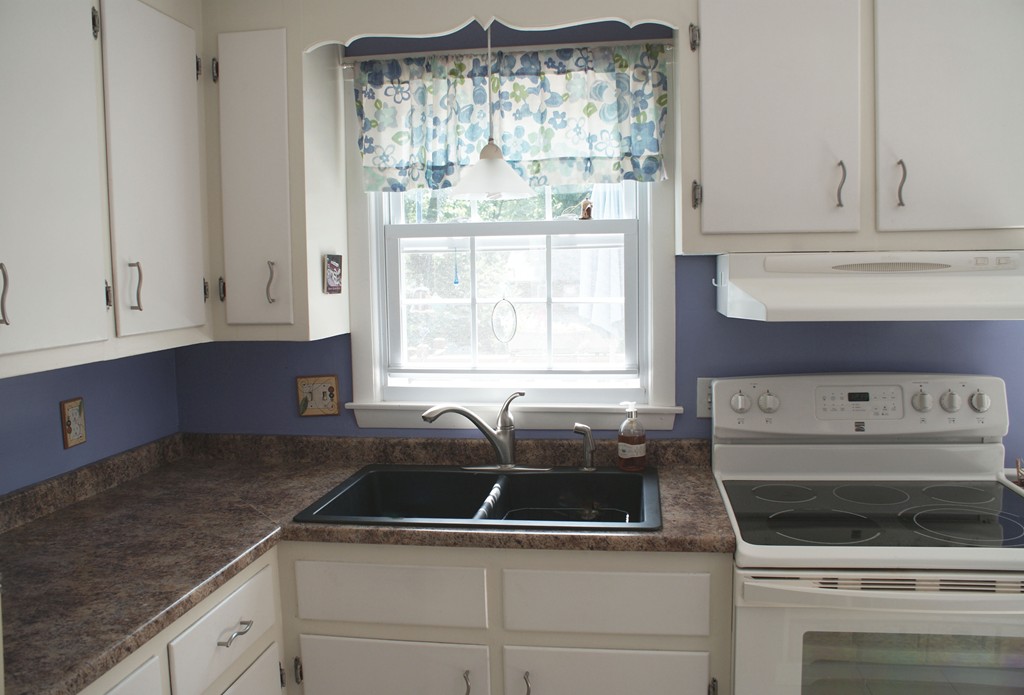 149 Endecott Street Springfield, MA 01118 - Photo 5 of 23 a kitchen with granite countertop white cabinets and white appliances