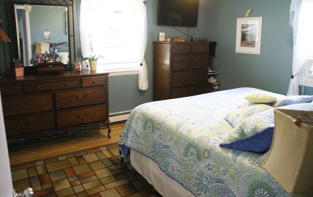 149 Endecott Street Springfield, MA 01118 - Photo 10 of 23 a bedroom with a bed and a dresser