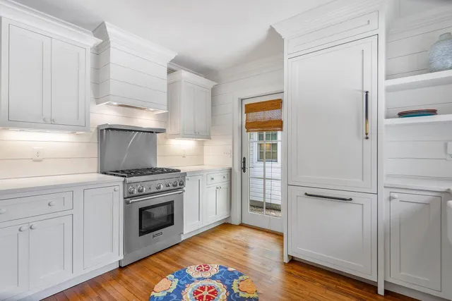 a kitchen with a stove top oven and a refrigerator