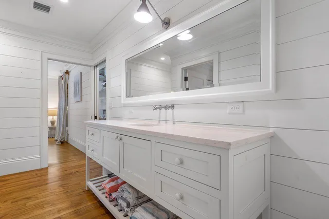 a spacious bathroom with double vanity and mirrors