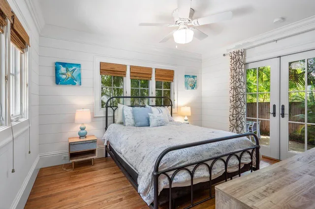 a bedroom with a large bed and a chandelier