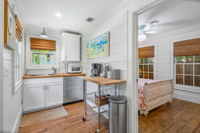 a large white kitchen with sink and window