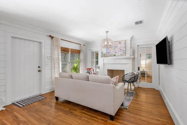 a living room with furniture a flat screen tv and a fireplace