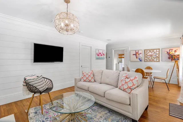 a living room with furniture and a flat screen tv