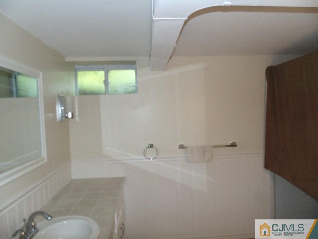 67 Tunison Road New Brunswick, NJ 08901 - Photo 2 of 2 a bathroom with a sink and tub