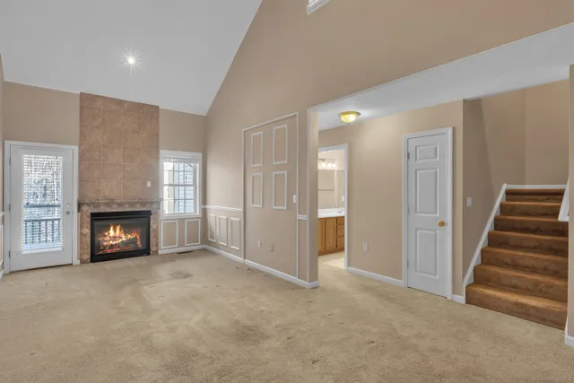 an empty room with fireplace and windows