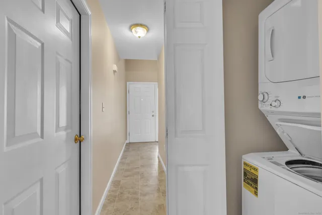 a view of a kitchen with a sink and a refrigerator