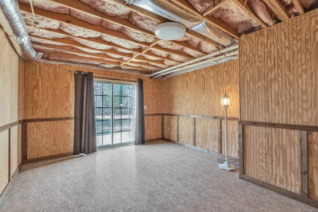 a view of empty room with fireplace and windows