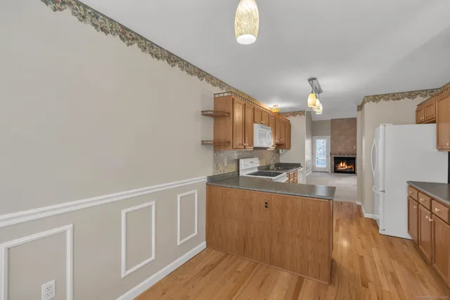 a kitchen with cabinets a sink and wooden floor