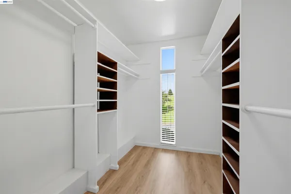 an entryway with wooden floor and windows