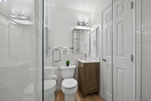 a bathroom with a granite countertop toilet sink and shower