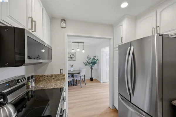 a kitchen with stainless steel appliances a refrigerator and wooden cabinets