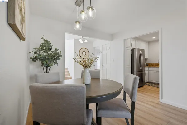 a view of a dining room with furniture and wooden floor