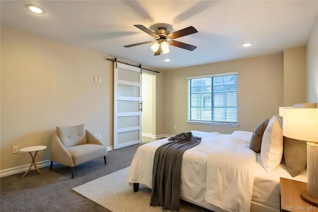 a bedroom with a bed and ceiling fan