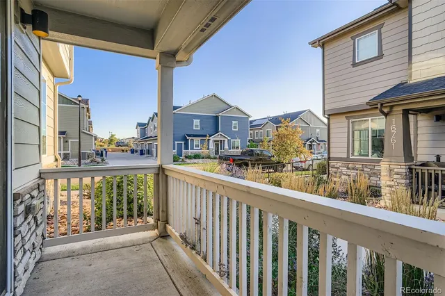 a view of a brick house with a small yard